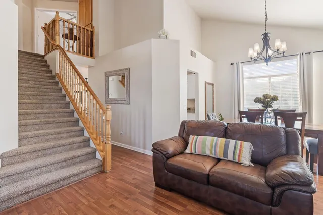 a living room with furniture and a chandelier