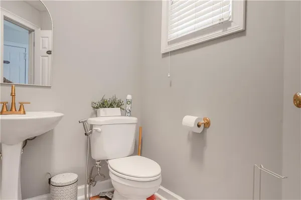a white toilet sitting next to a bathroom sink