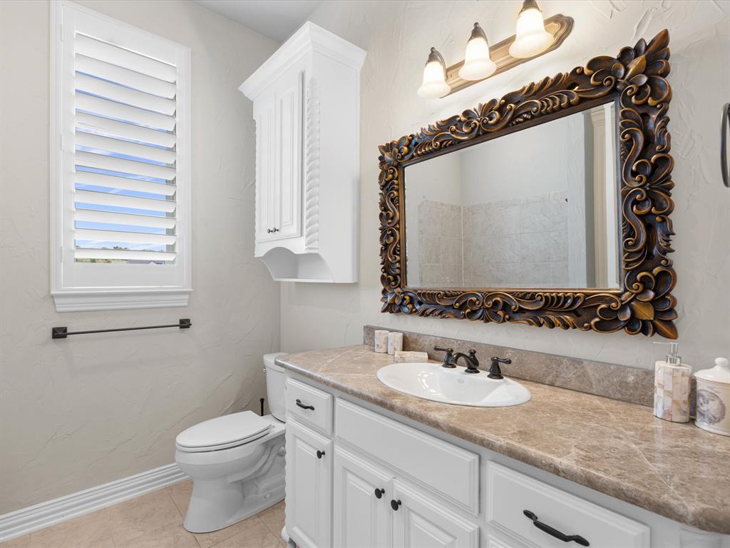 107 Marina Del Ray Bridgeport, TX 76426 - Photo 27 of 40 a bathroom with a granite countertop sink mirror vanity and toilet