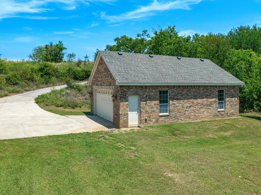107 Marina Del Ray Bridgeport, TX 76426 - Photo 35 of 40 a front view of a house with a garden