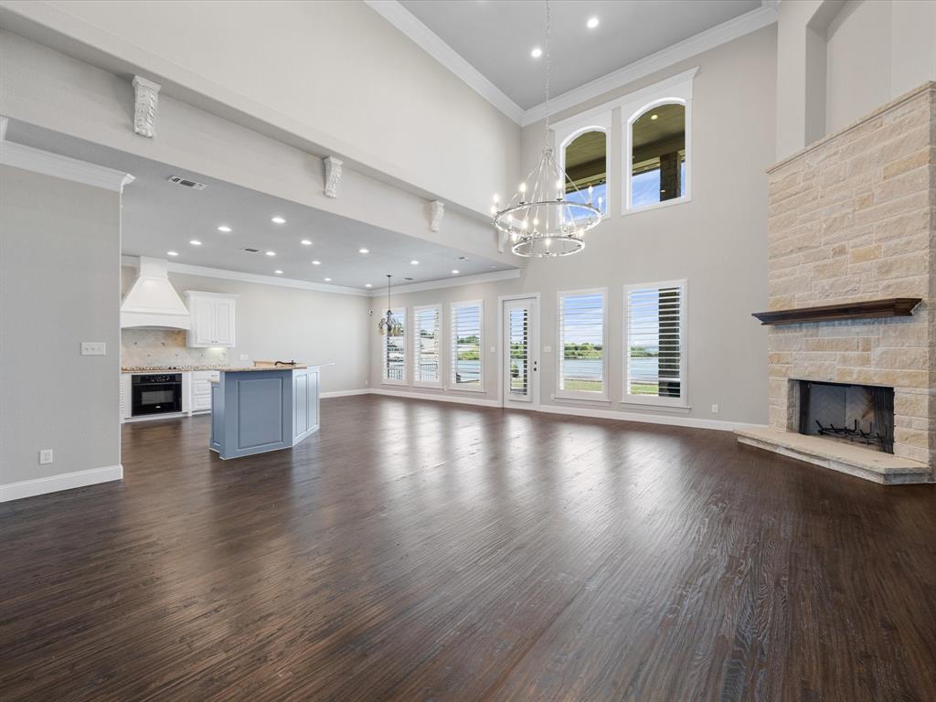 107 Marina Del Ray Bridgeport, TX 76426 - Photo 9 of 40 an empty room with wooden floor fireplace and windows