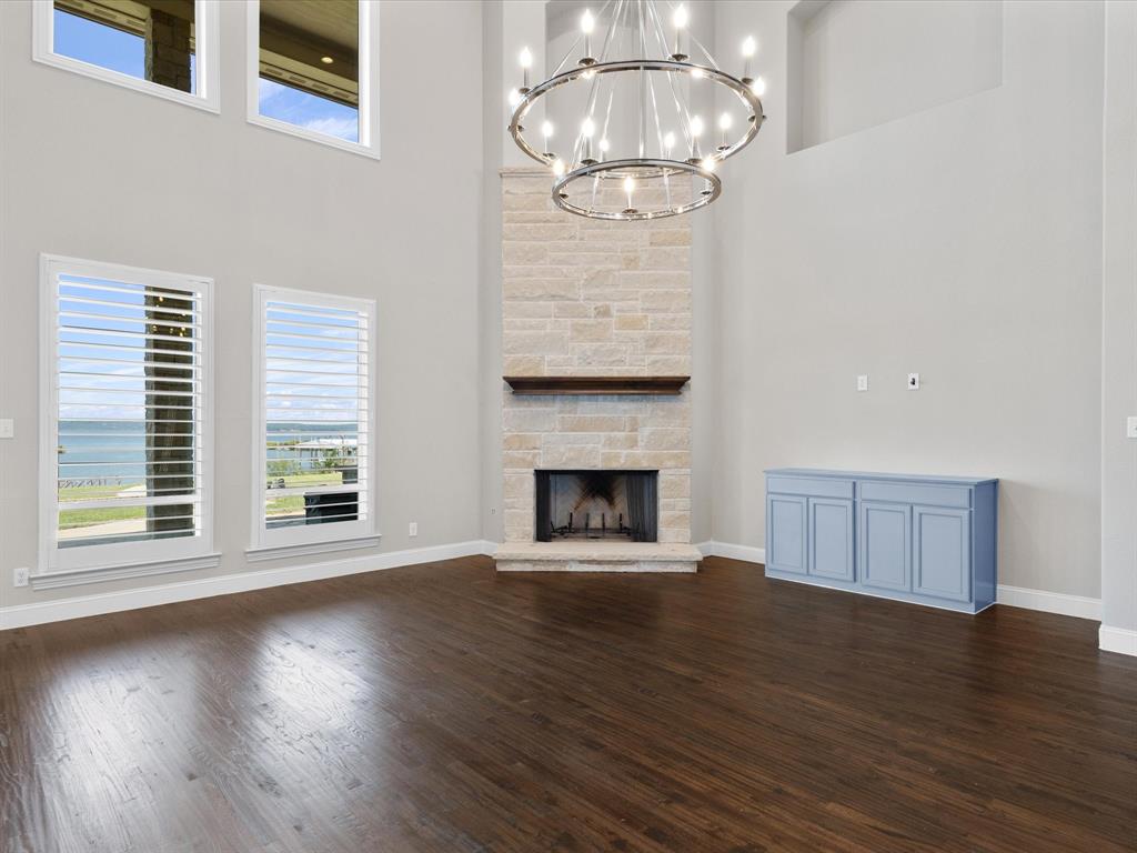 107 Marina Del Ray Bridgeport, TX 76426 - Photo 10 of 40 a view of an empty room with wooden floor fireplace and a window