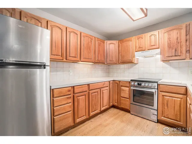 a kitchen with stainless steel appliances granite countertop a refrigerator sink and cabinets