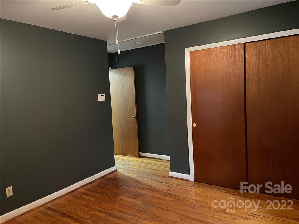 612 Mcdade Road Tryon, NC 28782 - Photo 16 of 27 an empty room with wooden floor and windows
