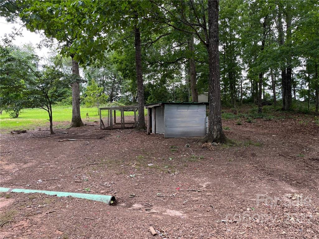 612 Mcdade Road Tryon, NC 28782 - Photo 20 of 27 a view of a backyard with large trees