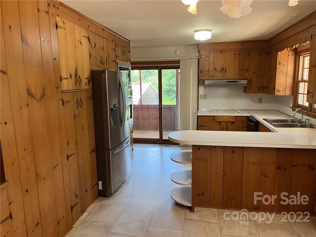 612 Mcdade Road Tryon, NC 28782 - Photo 6 of 27 a kitchen with a refrigerator and a sink