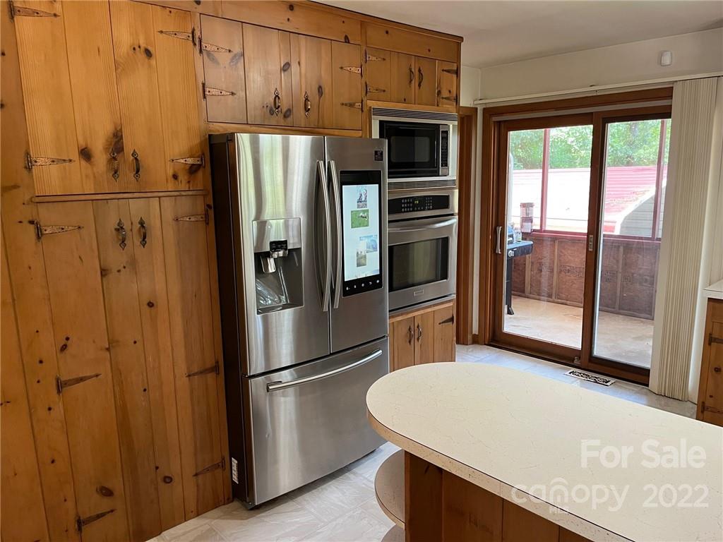 612 Mcdade Road Tryon, NC 28782 - Photo 7 of 27 a kitchen with stainless steel appliances a refrigerator and a stove top oven