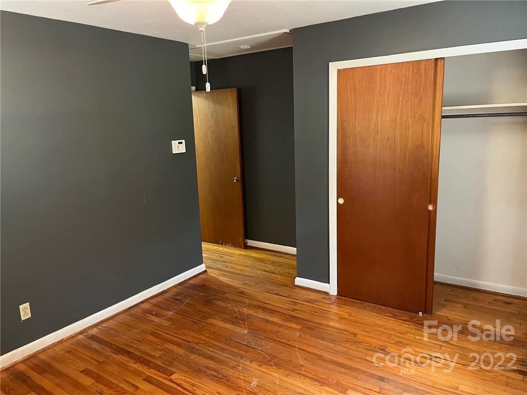 612 Mcdade Road Tryon, NC 28782 - Photo 9 of 27 an empty room with wooden floor and closet