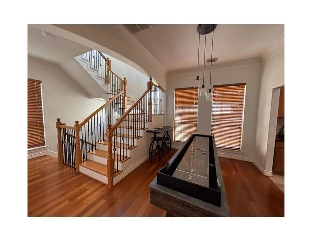 a view of staircase with furniture and a window