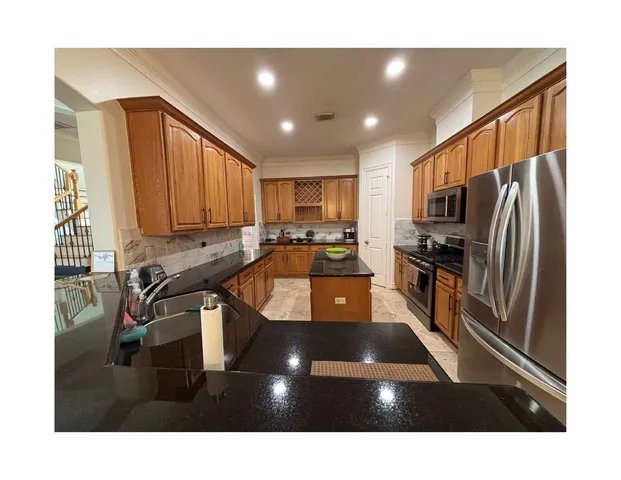 a kitchen with a sink stainless steel appliances and cabinets