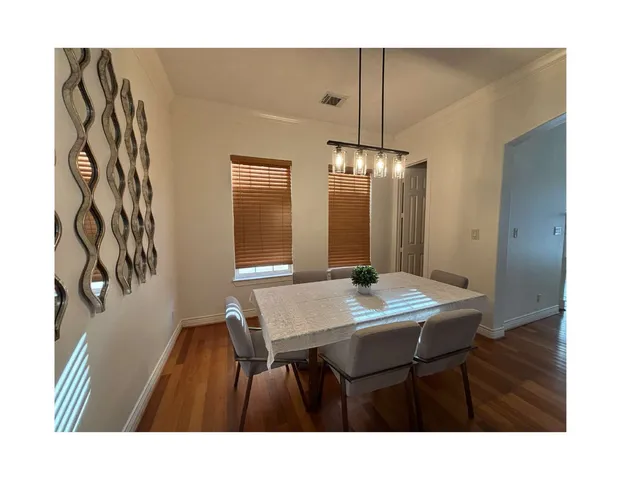 a dining room with a table chairs and a chandelier