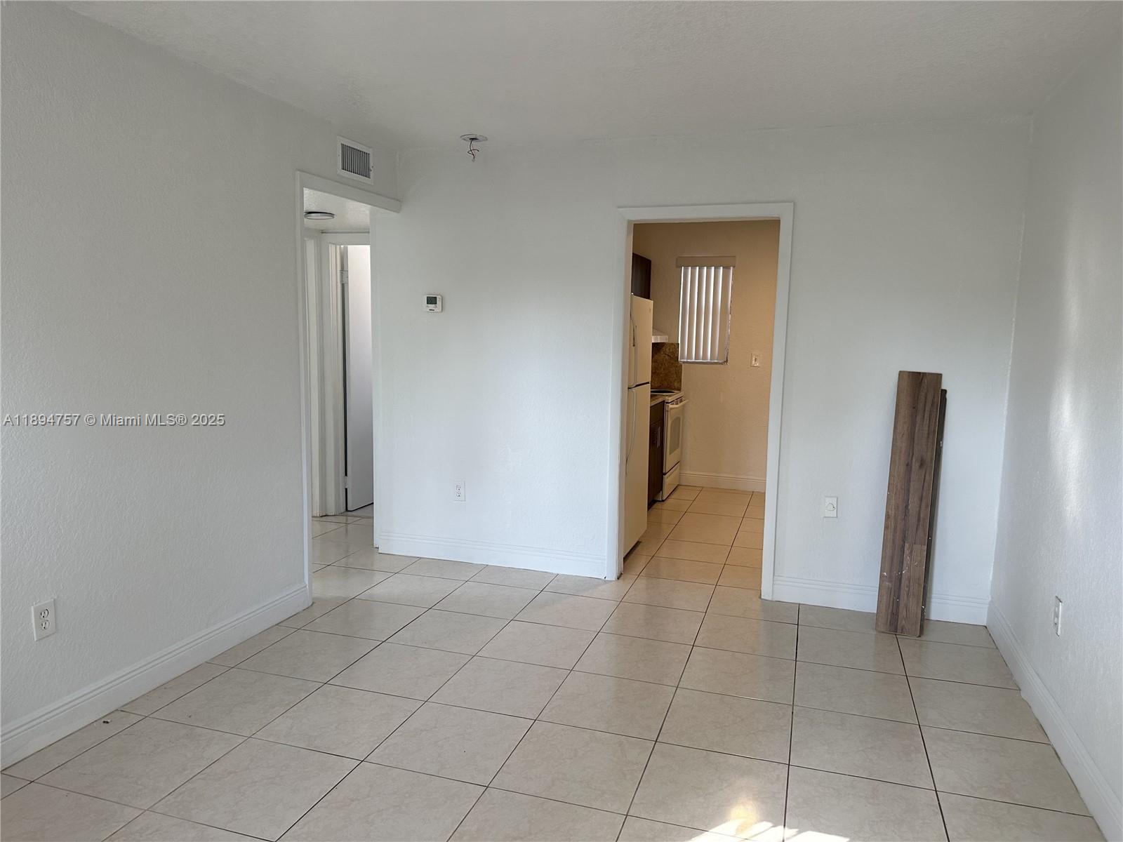 a view of a hallway to rooms