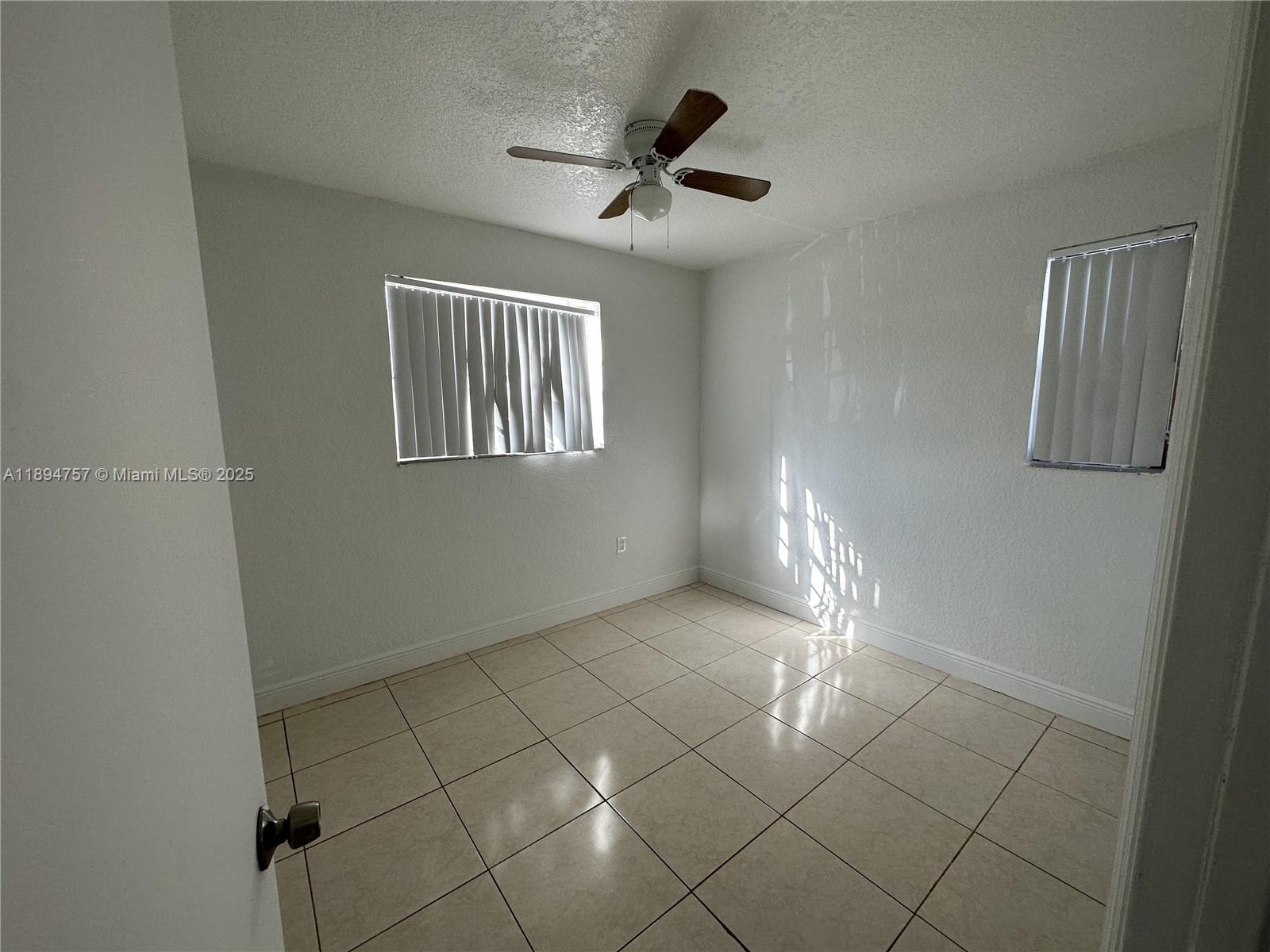 1851 Ali Baba Avenue, Unit 4 Opa-Locka, FL 33054 - Photo 5 of 6 a view of an empty room with a window