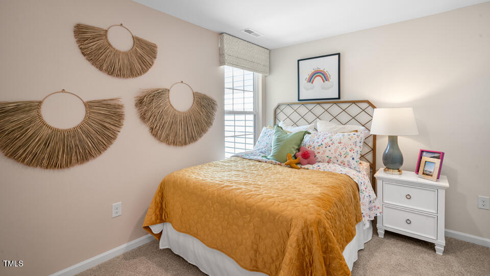 8519 Beckett Chase Way Raleigh, NC 27616 - Photo 20 of 29 a bedroom with a bed and a painting on the wall