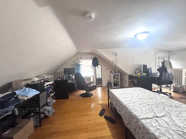 a living room with dining room and wooden floor