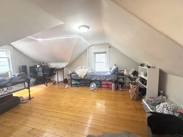 a living room with lots of furniture and a wooden floor