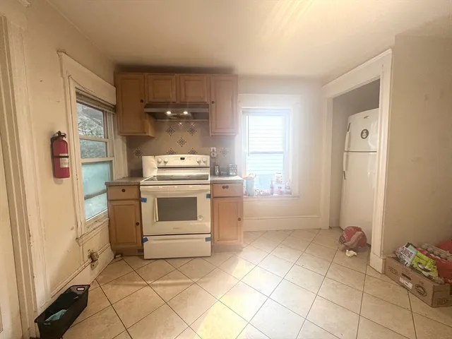 a kitchen with a stove top oven and cabinets
