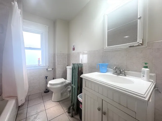 a bathroom with a sink toilet and mirror
