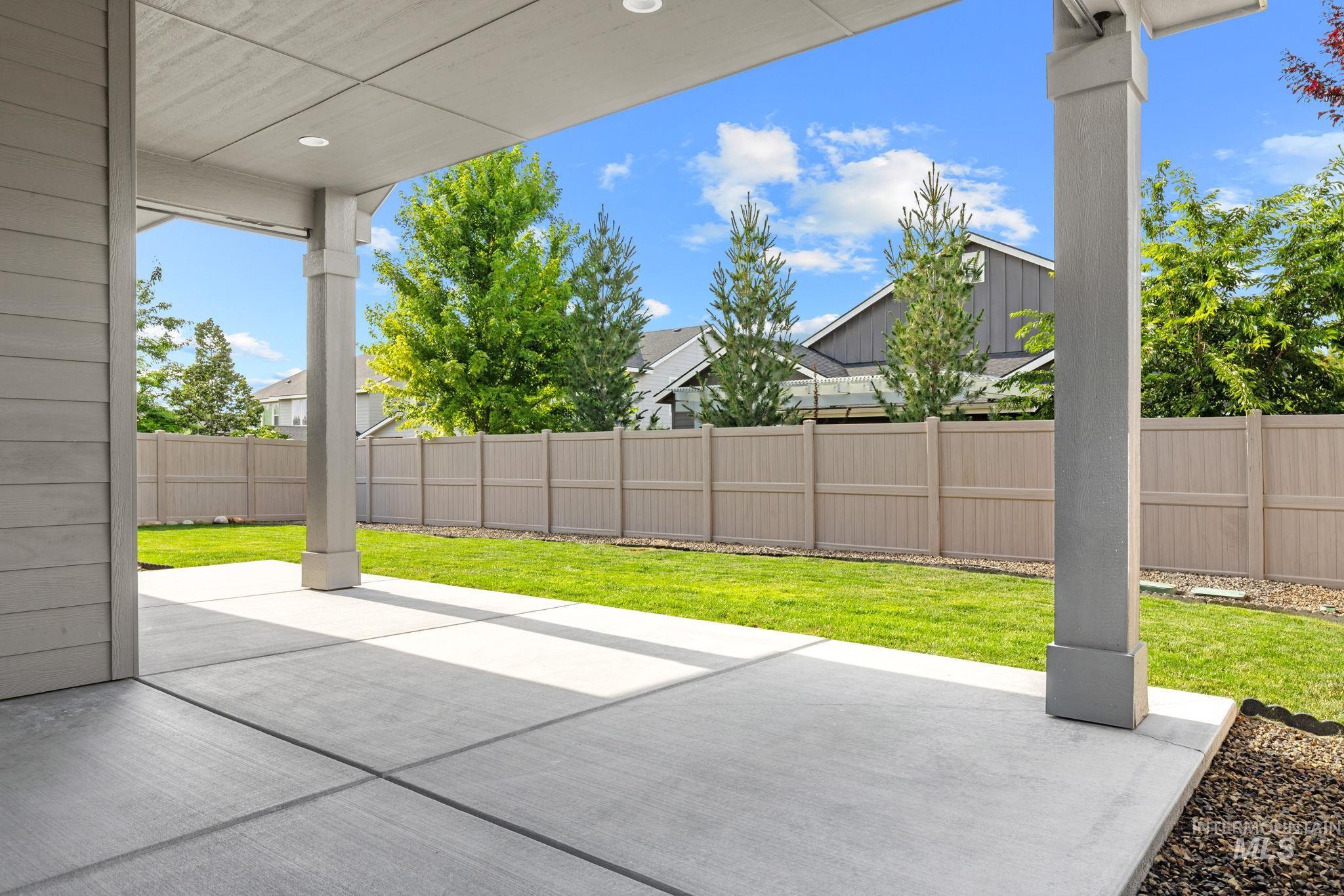 2934 East Murchison Street Meridian, ID 83642 - Photo 41 of 44 Expansive backyard featuring a lush lawn, concrete patio, and full perimeter fencing