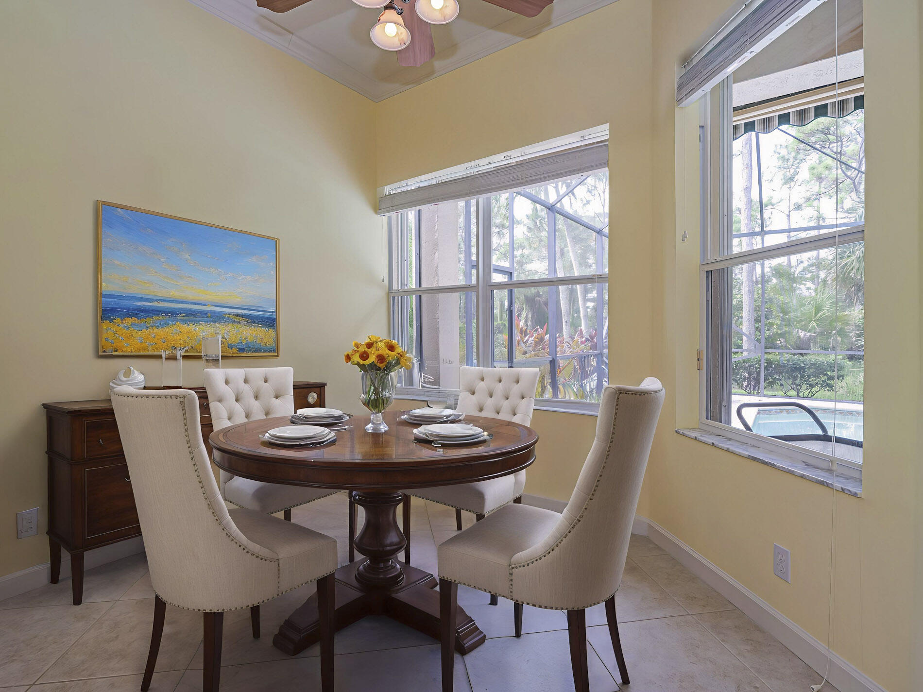 6871 Southeast Twin Oaks Circle Stuart, FL 34997 - Photo 11 of 34 a view of a dining room with furniture large windows and wooden floor