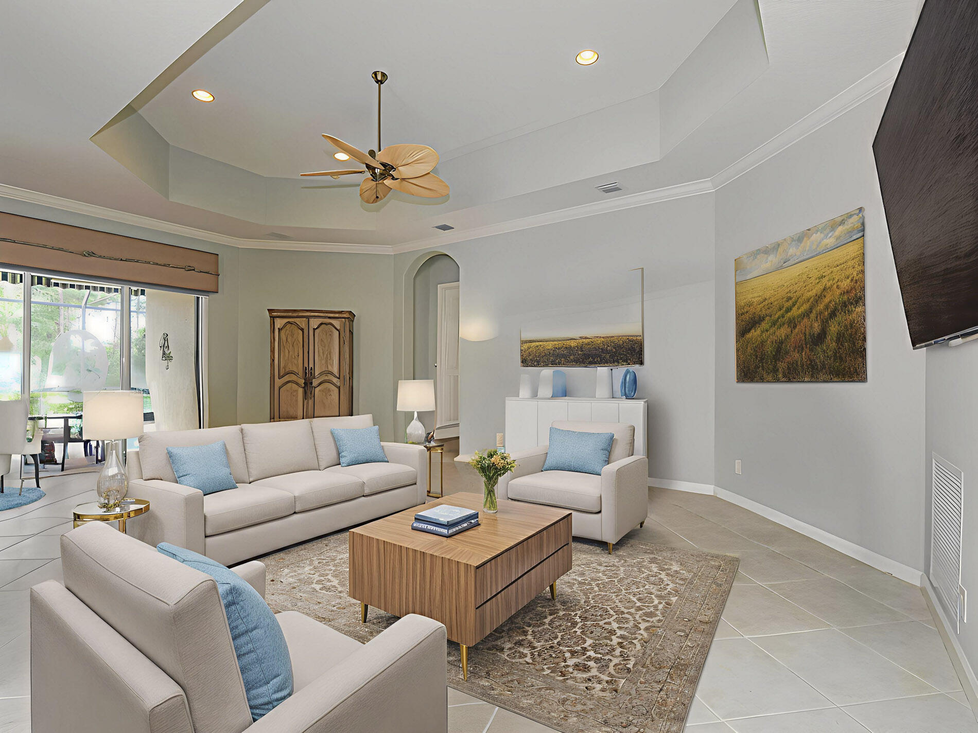 6871 Southeast Twin Oaks Circle Stuart, FL 34997 - Photo 6 of 34 a living room with furniture a ceiling fan and a window