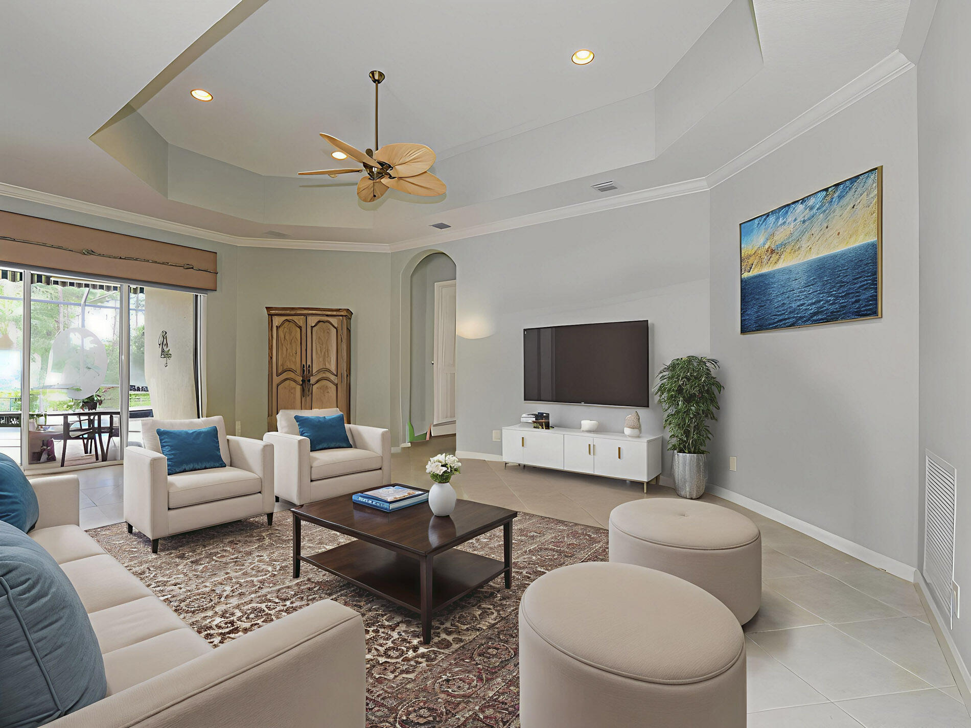 6871 Southeast Twin Oaks Circle Stuart, FL 34997 - Photo 7 of 34 a living room with furniture a rug and a flat screen tv