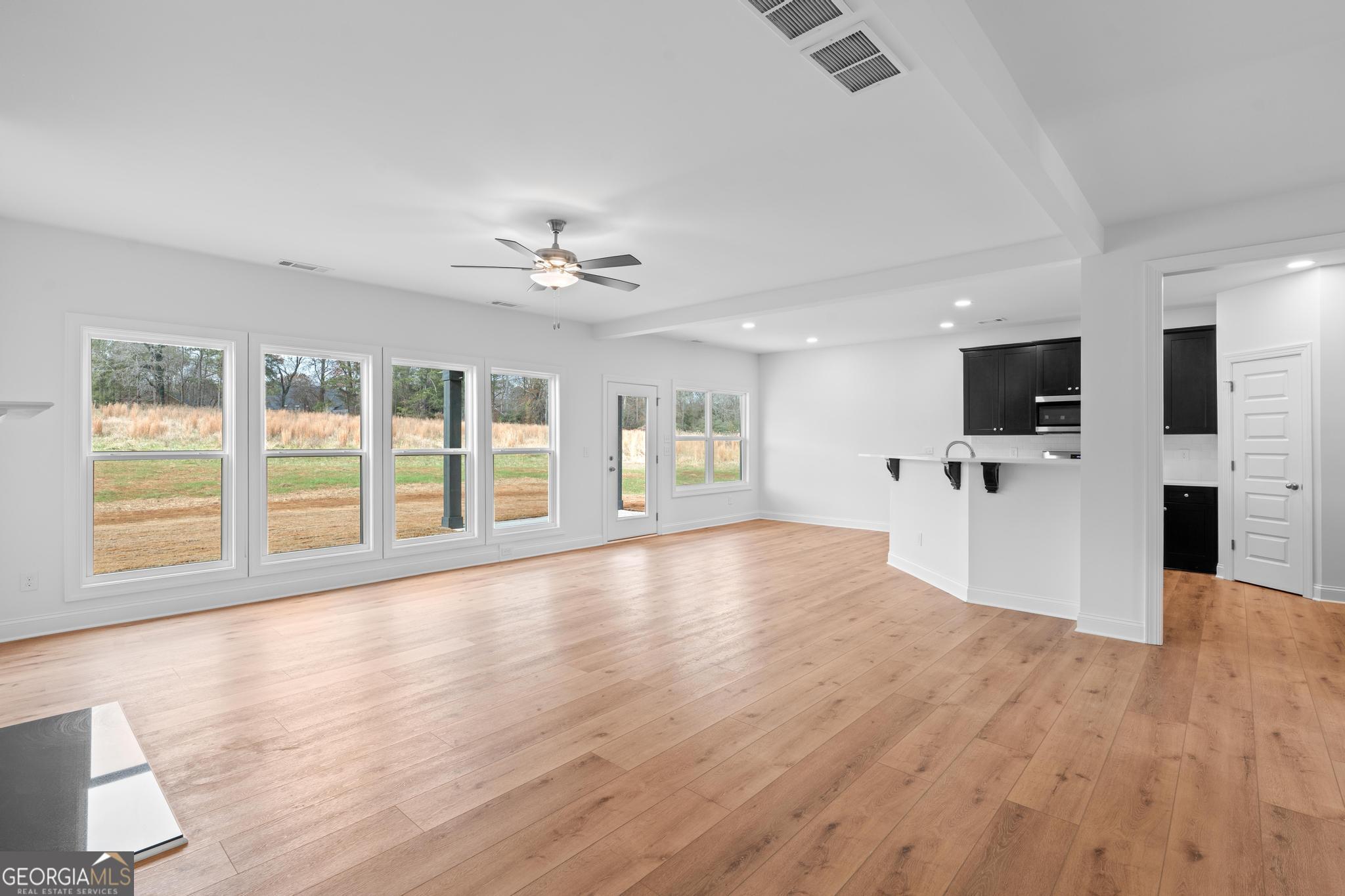 2305 New Hope Road, Unit (LOT 5) Locust Grove, GA 30248 - Photo 17 of 45 a view of an empty room with kitchen and a window