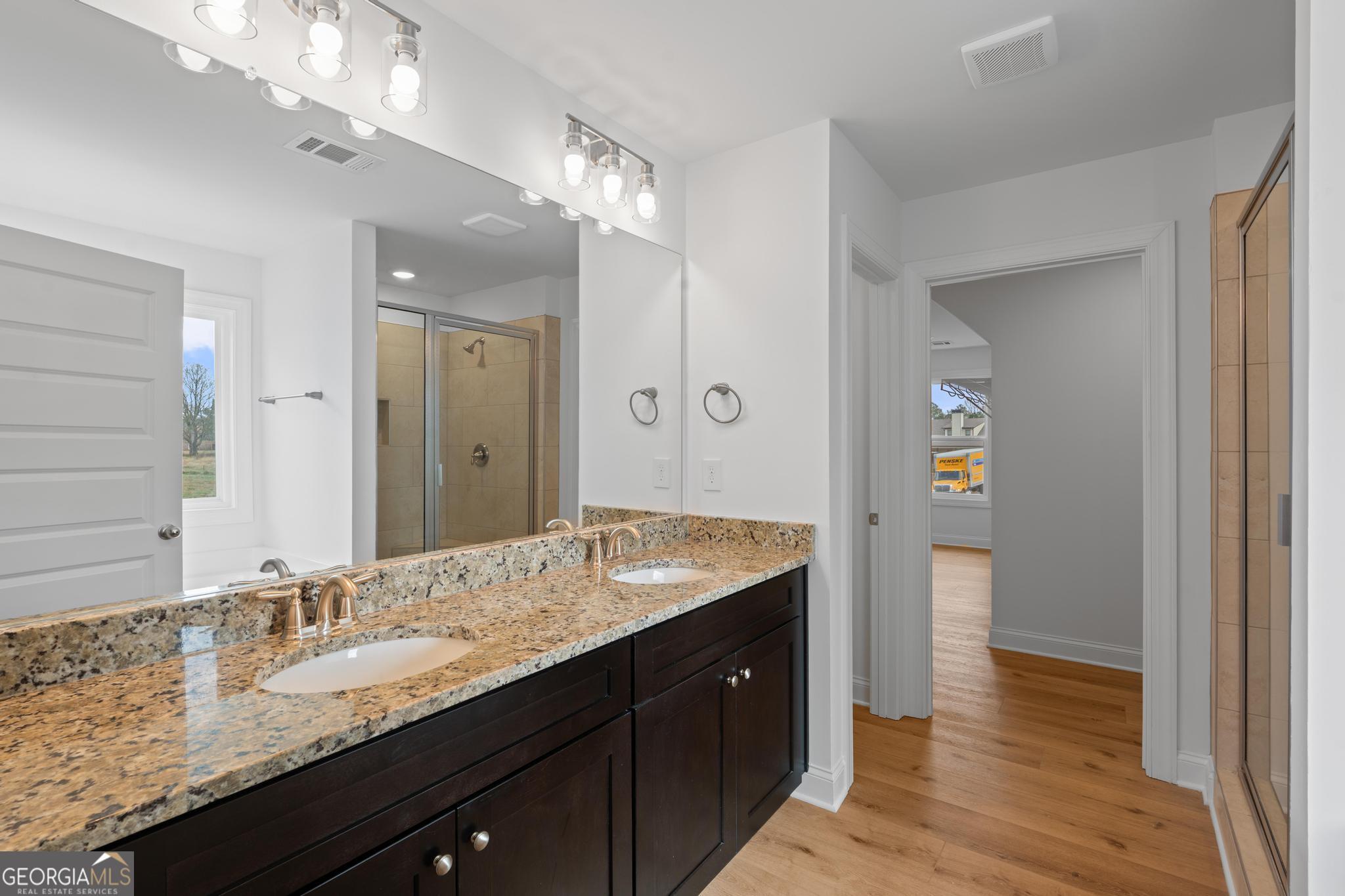 2305 New Hope Road, Unit (LOT 5) Locust Grove, GA 30248 - Photo 32 of 45 a bathroom with a granite countertop sink double vanity and a mirror