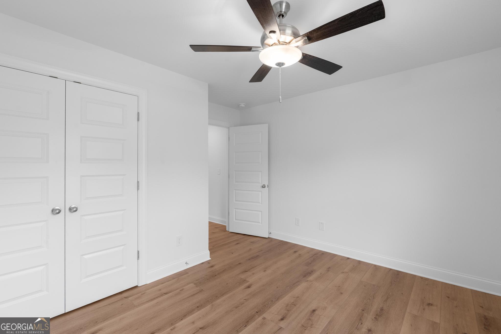 2305 New Hope Road, Unit (LOT 5) Locust Grove, GA 30248 - Photo 43 of 45 an empty room with wooden floor closet and fan