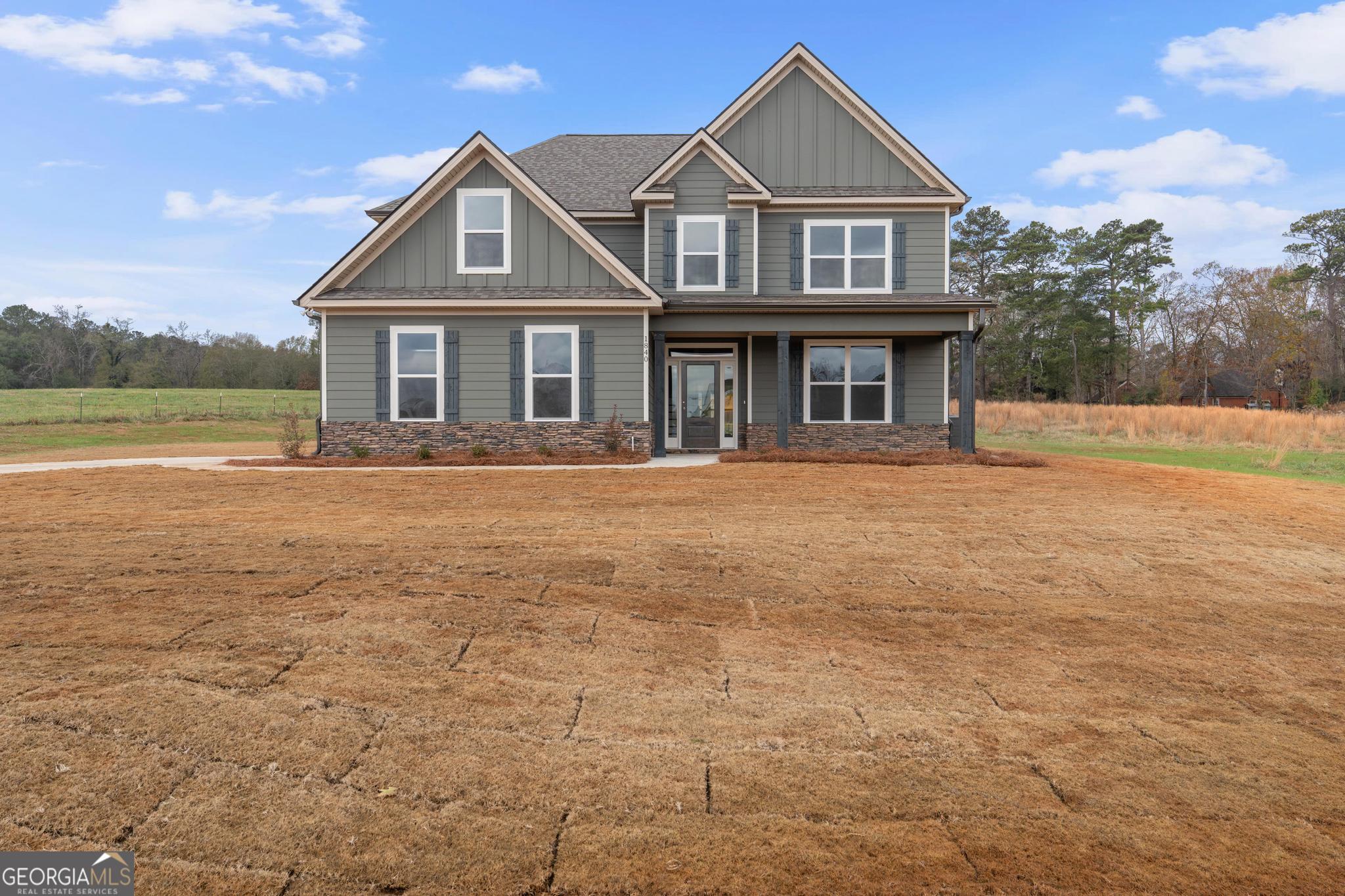 2305 New Hope Road, Unit (LOT 5) Locust Grove, GA 30248 - Photo 5 of 45 a front view of a house with garden