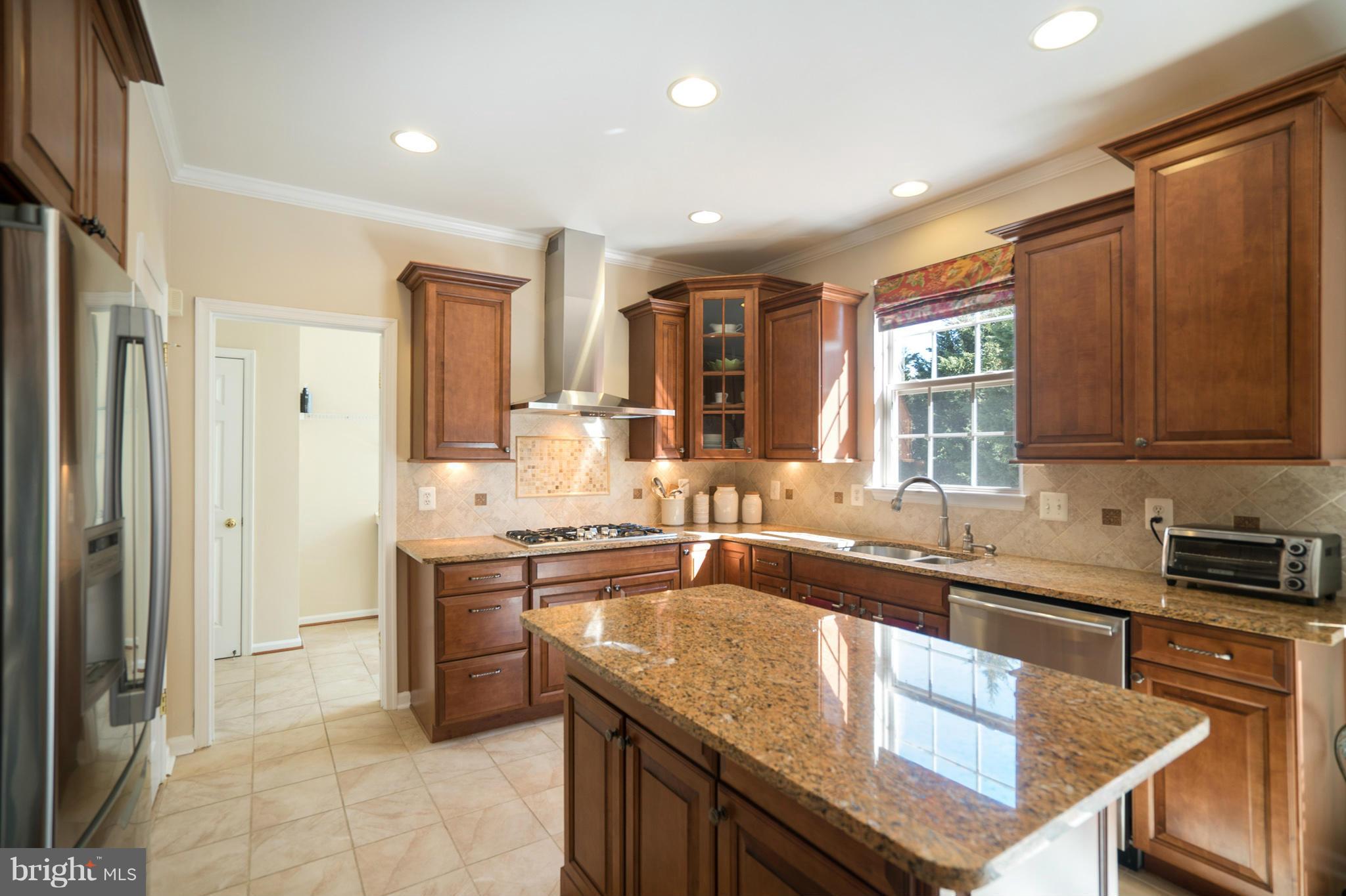 14202 Brass Wheel Road Boyds, MD 20841 - Photo 11 of 27 a kitchen with stainless steel appliances granite countertop a sink stove and refrigerator