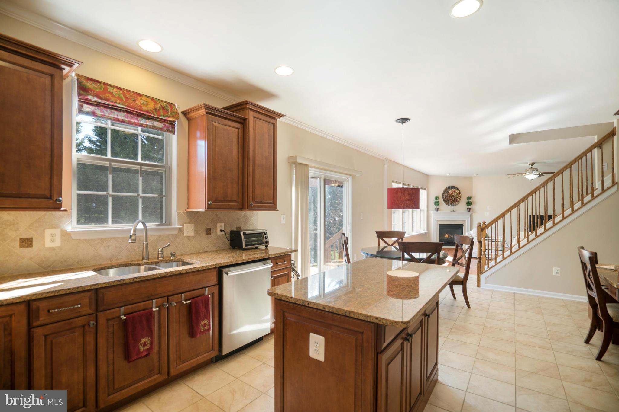 14202 Brass Wheel Road Boyds, MD 20841 - Photo 13 of 27 a kitchen with granite countertop a sink and a stove top oven