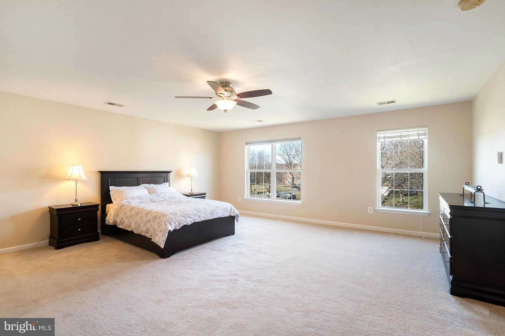 14202 Brass Wheel Road Boyds, MD 20841 - Photo 14 of 27 a spacious bedroom with a bed and window