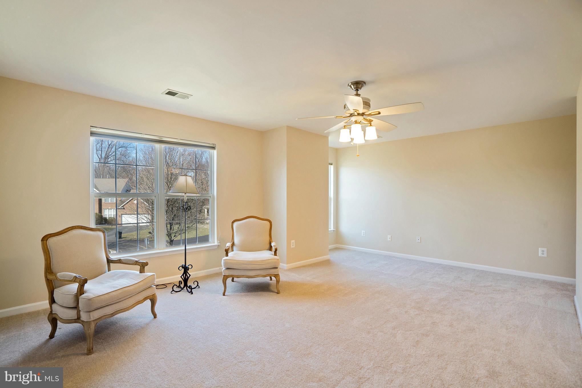 14202 Brass Wheel Road Boyds, MD 20841 - Photo 18 of 27 a living room with furniture and a chandelier