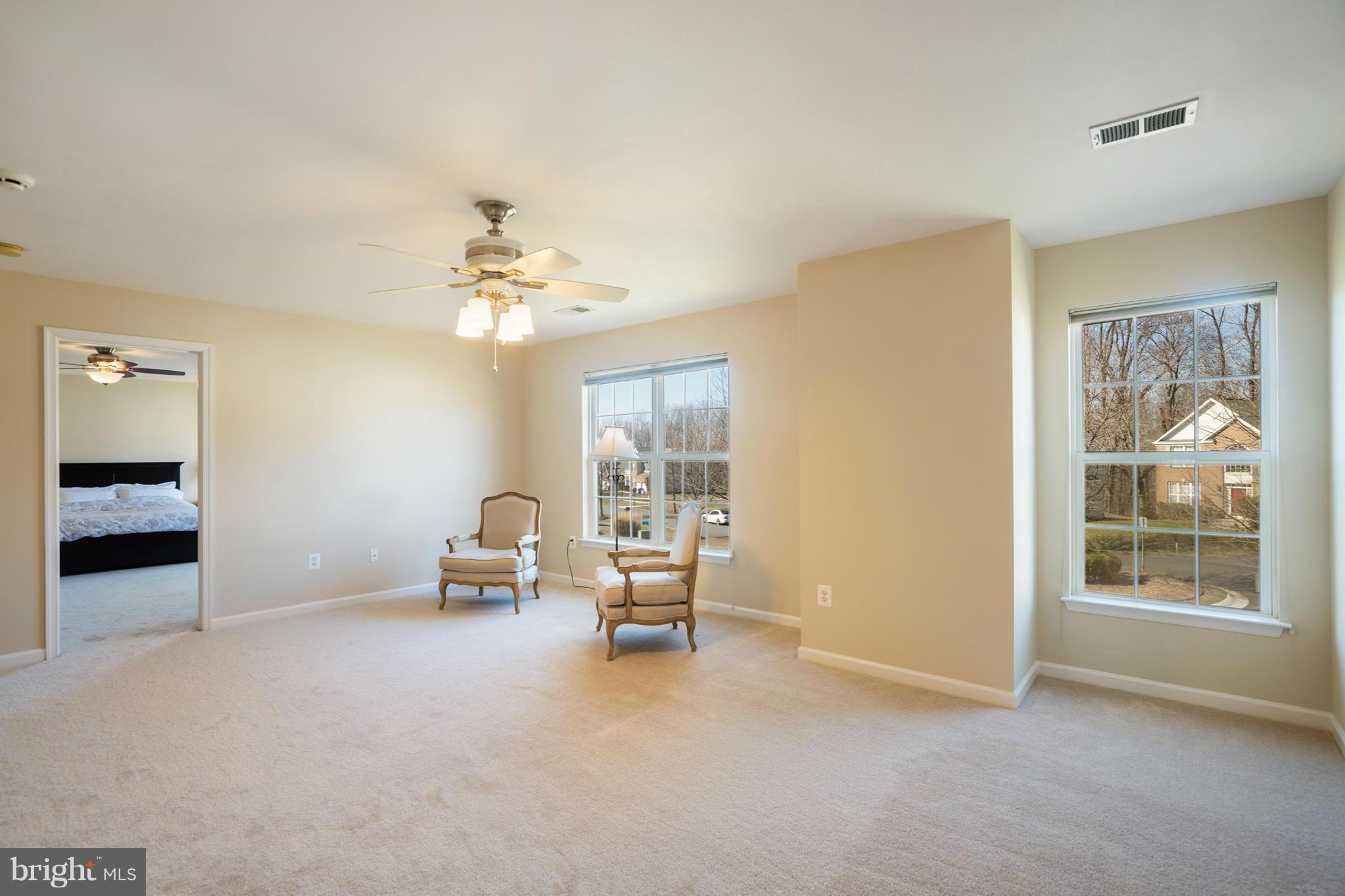 14202 Brass Wheel Road Boyds, MD 20841 - Photo 19 of 27 a living room with furniture and a chandelier