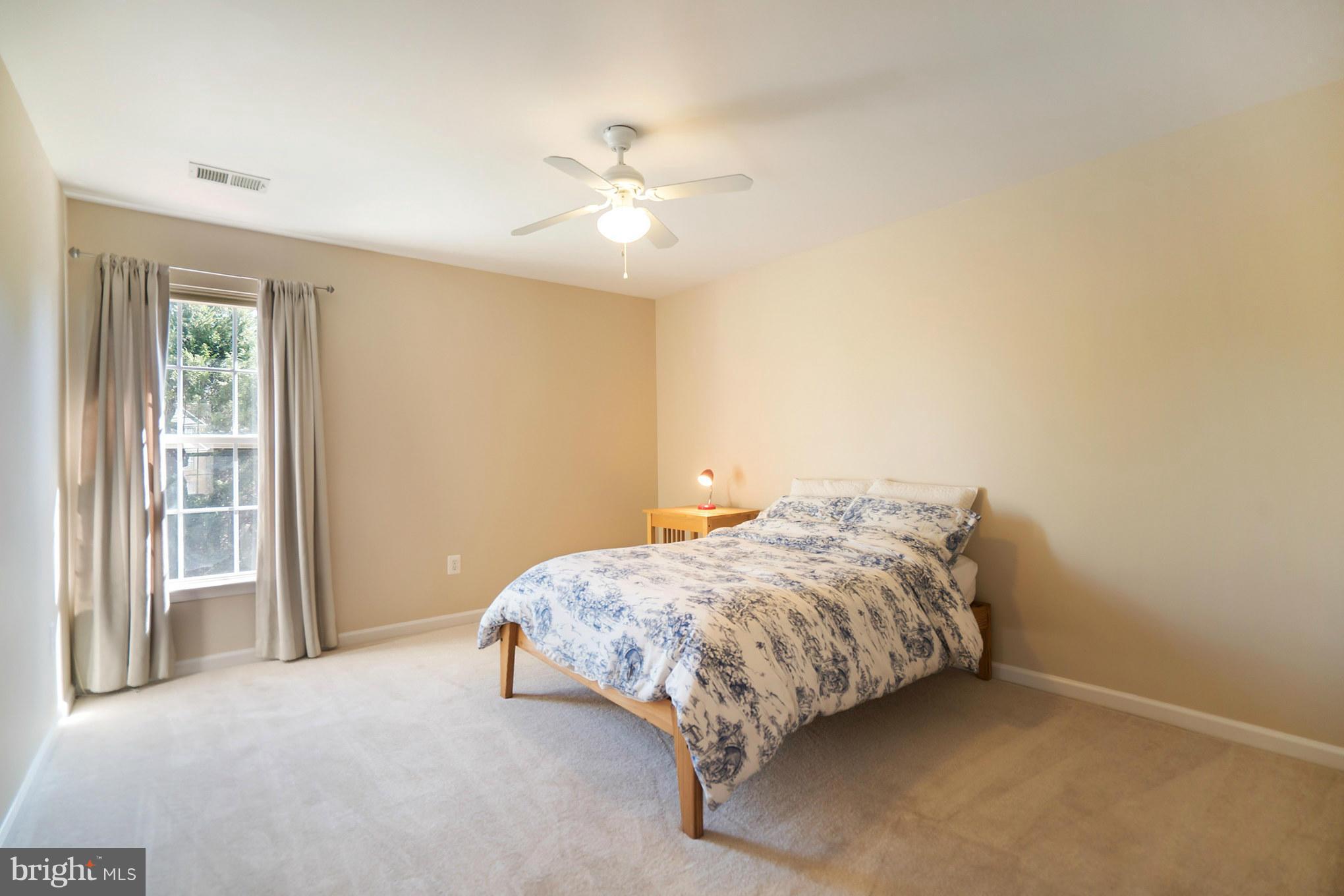 14202 Brass Wheel Road Boyds, MD 20841 - Photo 22 of 27 a bedroom with bed and window