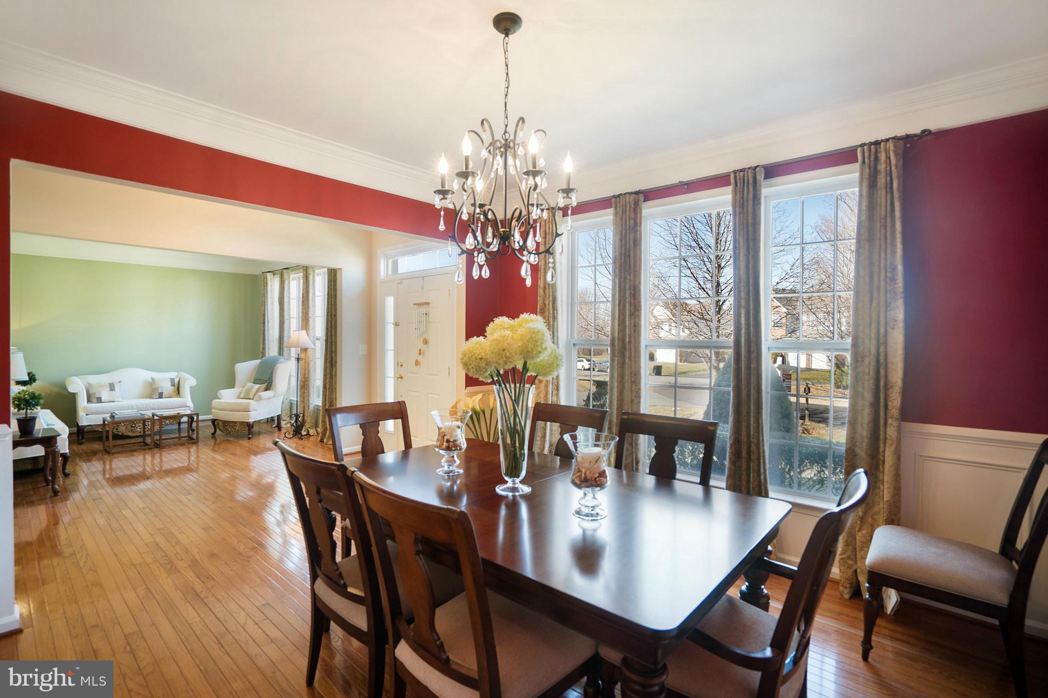 14202 Brass Wheel Road Boyds, MD 20841 - Photo 4 of 27 a view of a dining room with furniture wooden floor and chandelier