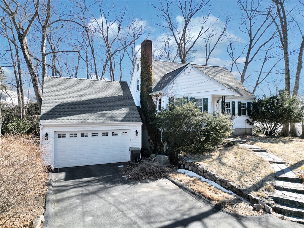 92 Intervale Road Dedham, MA 02026 - Photo 2 of 9 a view of a white house with a yard covered in snow