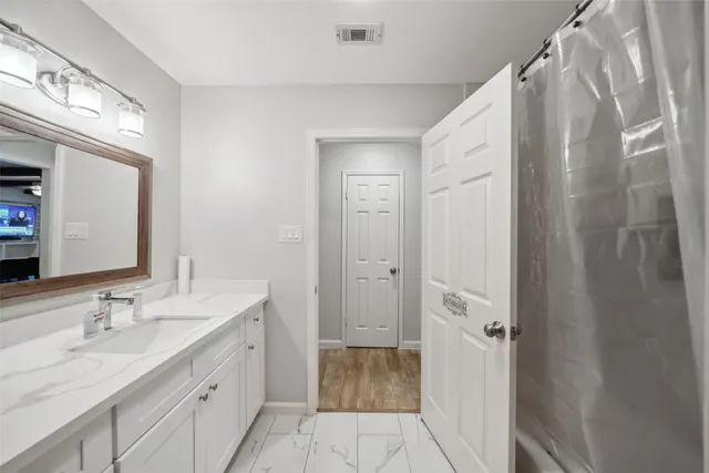 a bathroom with a double vanity sink and mirror