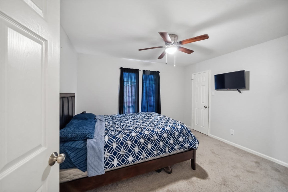 202 Black Forest Drive Spring, TX 77388 - Photo 19 of 29 a bedroom with a bed and a tv