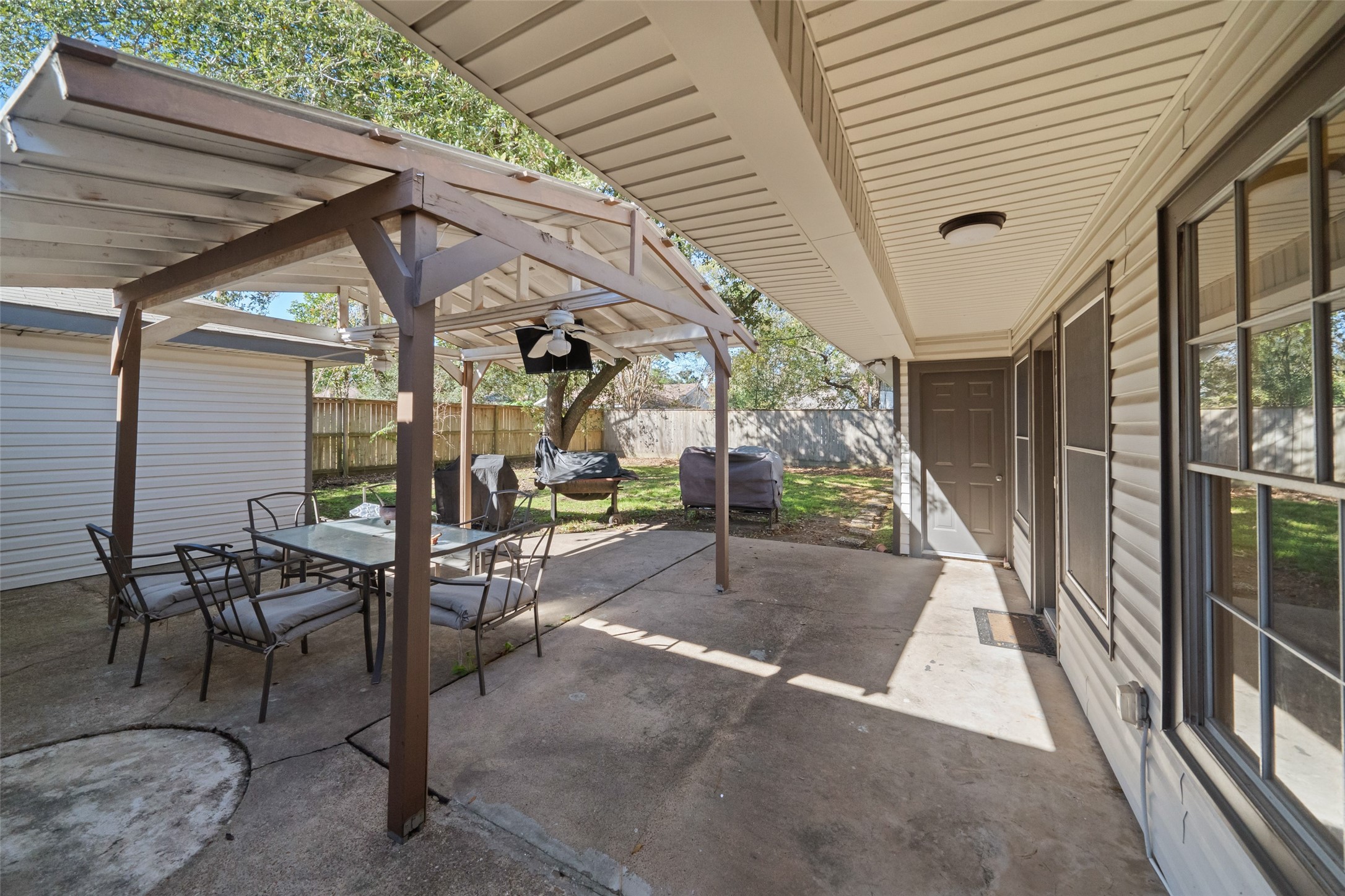 202 Black Forest Drive Spring, TX 77388 - Photo 25 of 29 FAMILY ROOM FLOWS OUT TO THE EXTERIOR ENTERTANING AREA, THE SPACIOUS PATIO AND BBQ COOKING SPACE. NICE PERGOLA PROVIDES SHADE FOR SUNNY DAYS