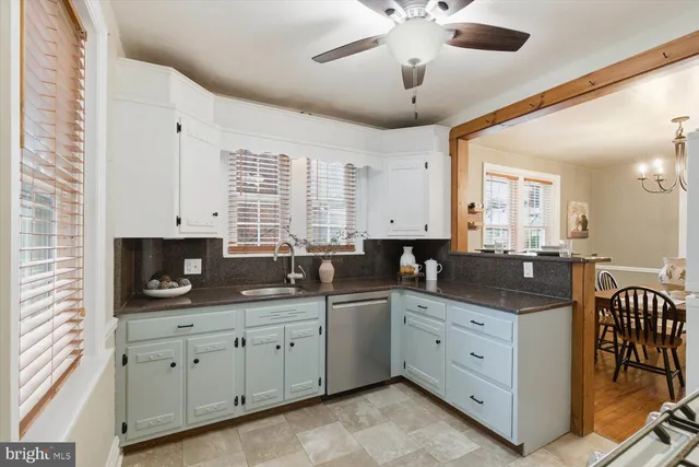 a kitchen with stainless steel appliances granite countertop a sink a stove and a window