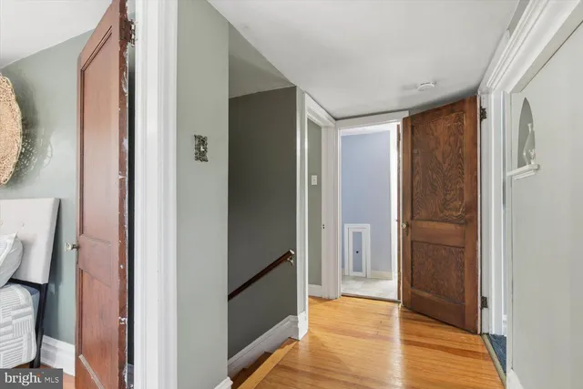 a bedroom with a bed dresser and window