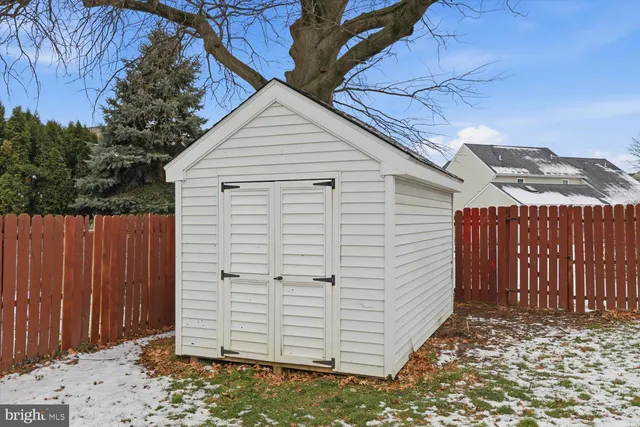 a view of backyard with a large tree