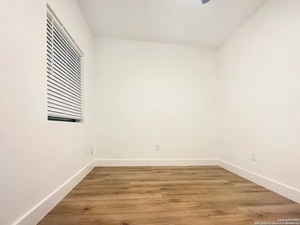 a view of a room with wooden floor
