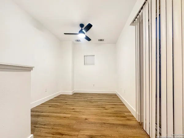 a view of a room with a staircase and ceiling fan