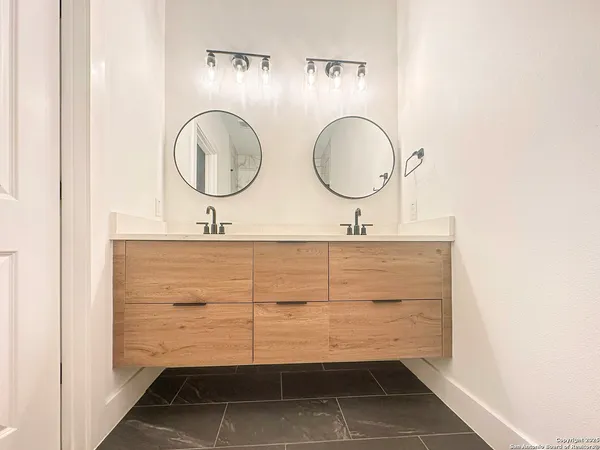 a bathroom with a sink mirror and vanity