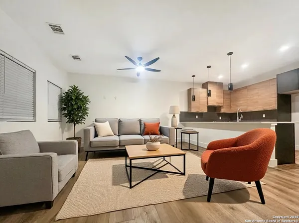 a living room with furniture and kitchen view