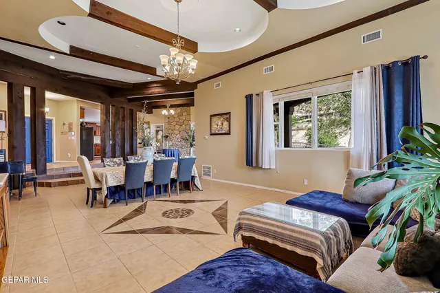 a kitchen with stainless steel appliances granite countertop a table chairs sink and cabinets