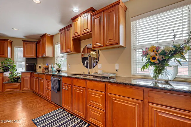 a bathroom with a granite countertop sink a toilet and a mirror